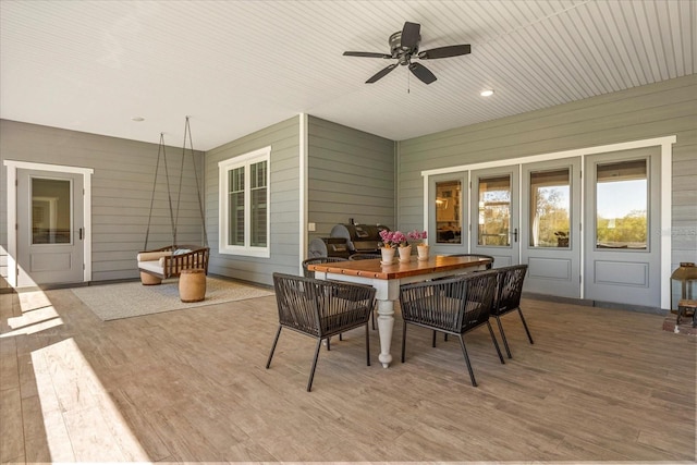 view of patio featuring ceiling fan, a wooden deck, and outdoor dining space
