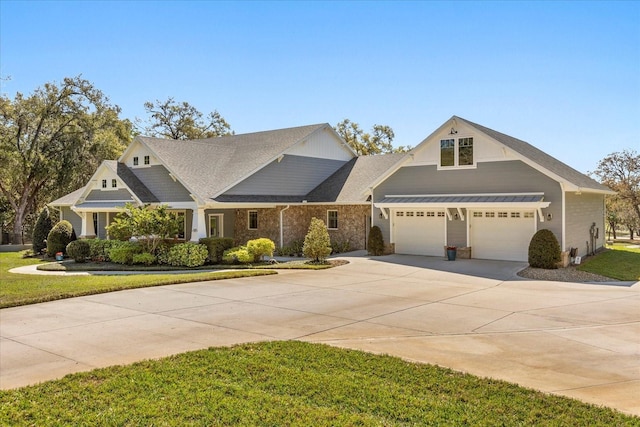 view of front facade with a front lawn, driveway, and a shingled roof