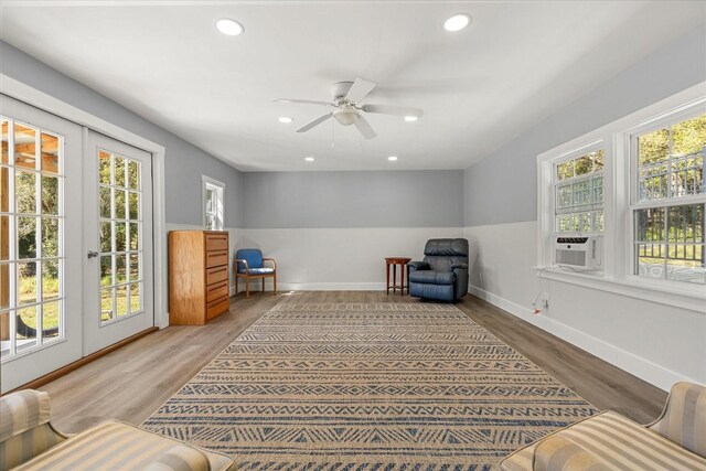 sitting room with wood finished floors, recessed lighting, and plenty of natural light