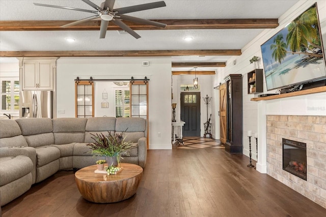 living room featuring dark wood-style flooring, a healthy amount of sunlight, and a ceiling fan