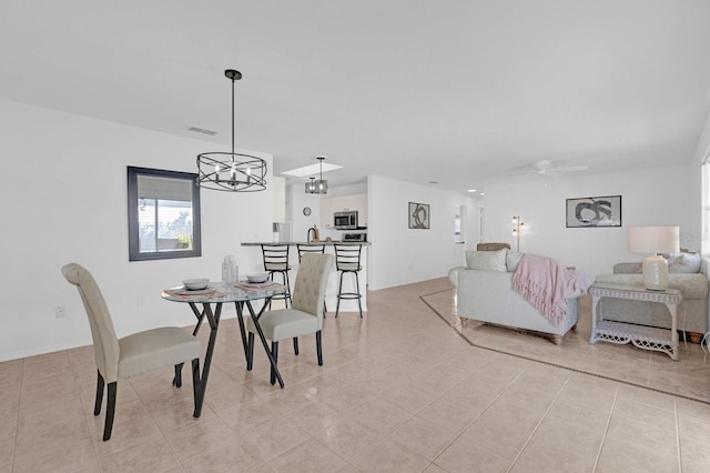 dining area featuring visible vents, ceiling fan, and light tile patterned floors