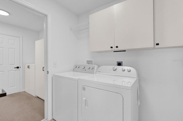 laundry room with carpet, cabinet space, and washing machine and clothes dryer