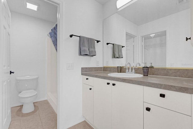 bathroom featuring toilet, a stall shower, tile patterned flooring, and vanity