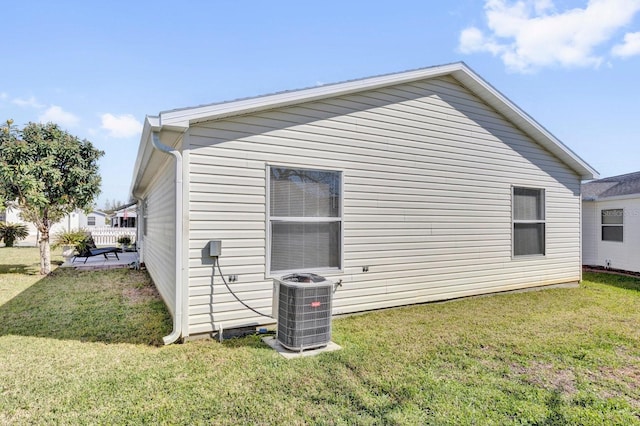 view of home's exterior with a yard and cooling unit