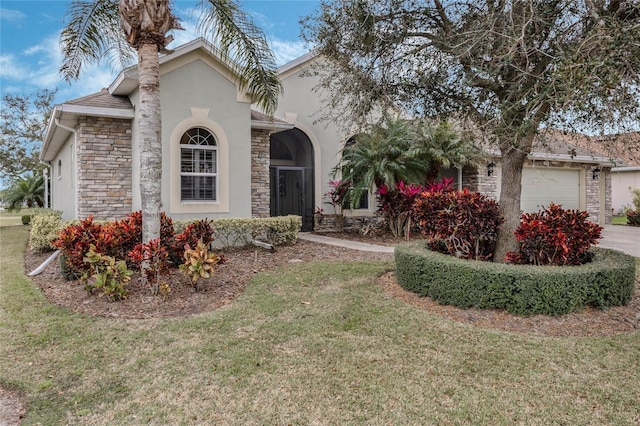 view of front of property featuring an attached garage, stone siding, a front lawn, and stucco siding