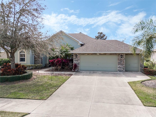 single story home with stone siding, concrete driveway, a shingled roof, and a garage