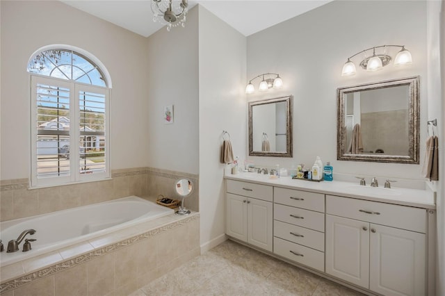 full bathroom featuring double vanity, tile patterned floors, a sink, and a bath