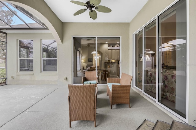 sunroom / solarium with a ceiling fan