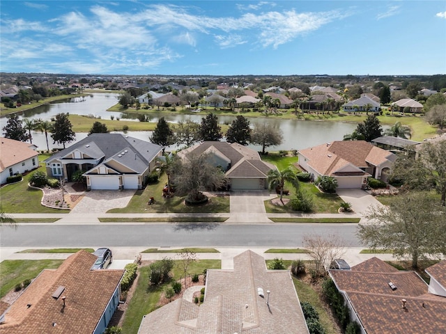 drone / aerial view with a water view and a residential view