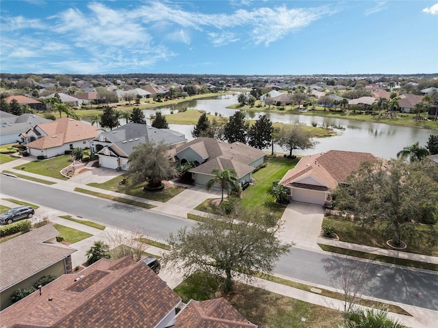 birds eye view of property with a water view and a residential view