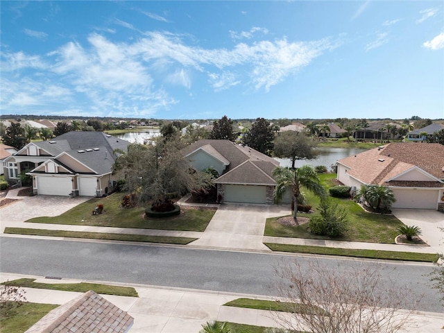 birds eye view of property featuring a residential view and a water view