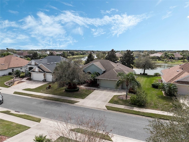 birds eye view of property with a water view and a residential view