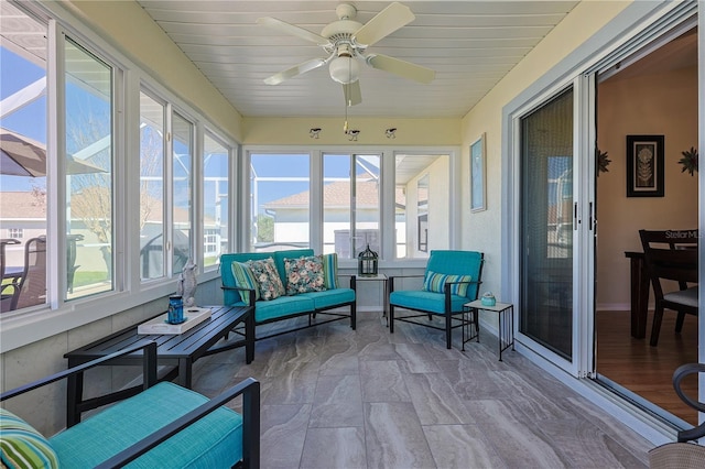 sunroom / solarium featuring ceiling fan