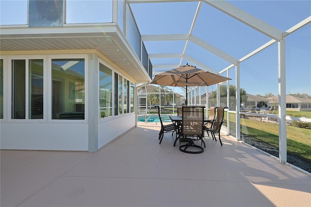 view of patio featuring glass enclosure and an outdoor pool