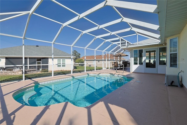 pool featuring a patio and glass enclosure