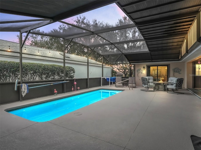 pool at dusk with a lanai, a patio area, and an outdoor pool