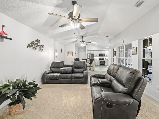 living area with lofted ceiling, visible vents, light carpet, a textured ceiling, and baseboards