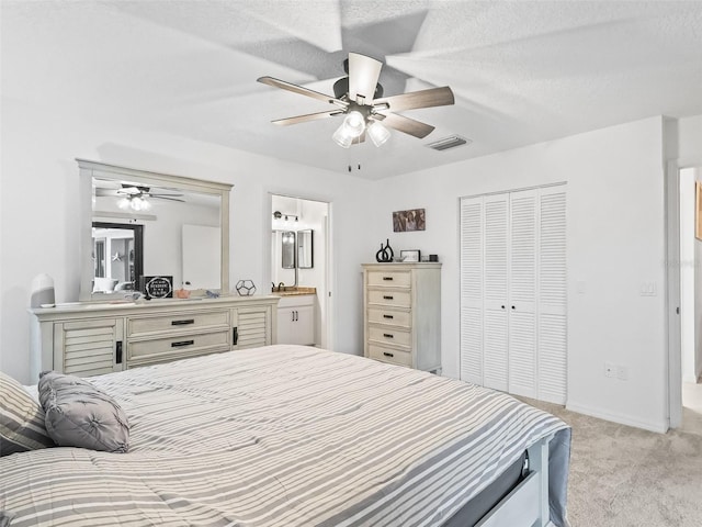 bedroom with light carpet, visible vents, baseboards, a ceiling fan, and a closet