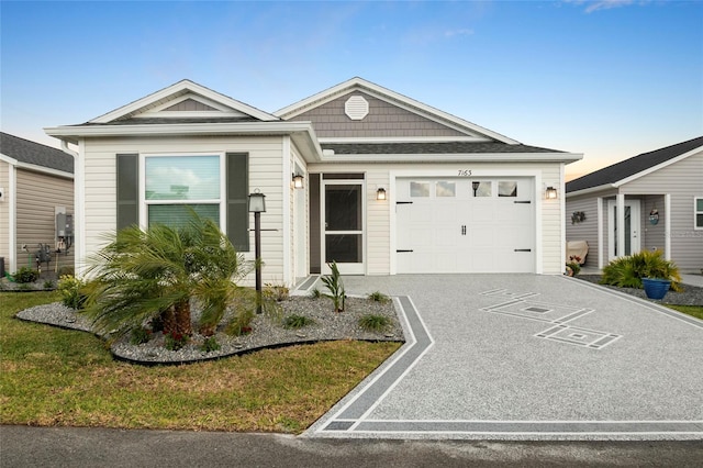 view of front of home with concrete driveway and an attached garage