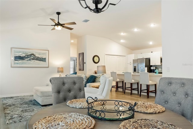 living area featuring a ceiling fan, visible vents, lofted ceiling, light wood-style flooring, and recessed lighting