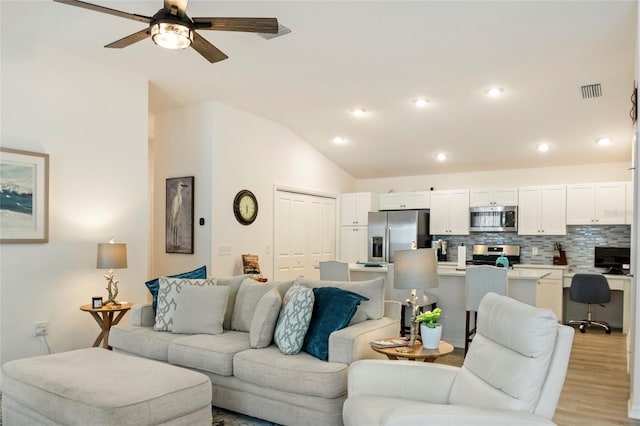 living room featuring a ceiling fan, visible vents, recessed lighting, vaulted ceiling, and light wood-type flooring