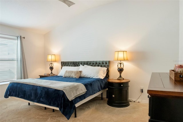 bedroom featuring baseboards, carpet, and vaulted ceiling