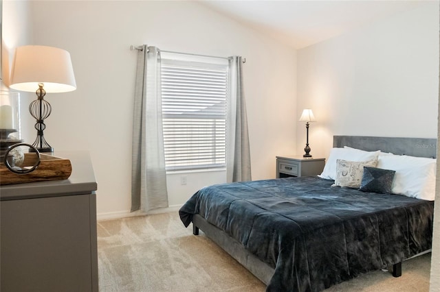 bedroom with baseboards, light carpet, and vaulted ceiling