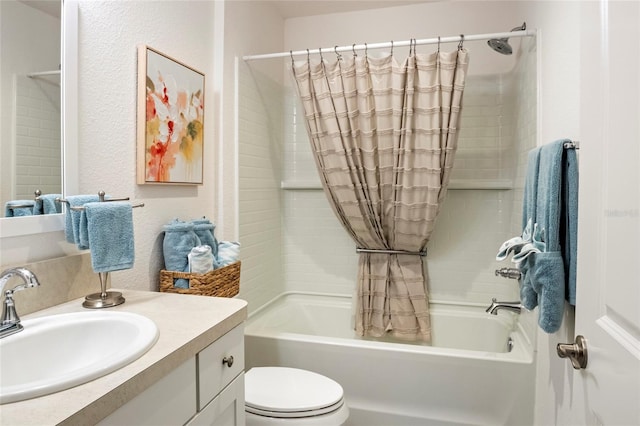 bathroom with toilet, vanity, a textured wall, and shower / bathtub combination with curtain