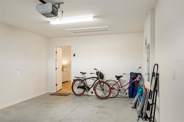 garage with a garage door opener and baseboards