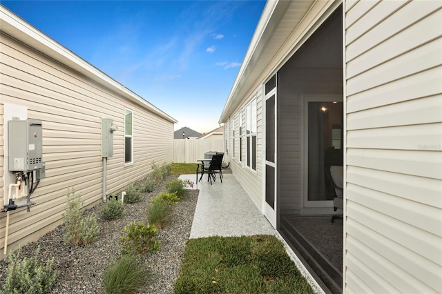 view of yard with water heater, a patio, and fence