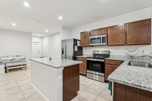 255 Blueberry Ln, Davenport, FL 33837 - kitchen featuring a sink, light tile patterned flooring, recessed lighting, a kitchen island, and appliances with stainless steel finishes