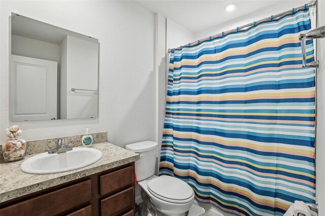 255 Blueberry Ln, Davenport, FL 33837 - full bathroom with a shower with curtain, vanity, and toilet