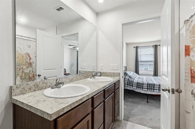 255 Blueberry Ln, Davenport, FL 33837 - full bath featuring visible vents, a sink, double vanity, and connected bathroom