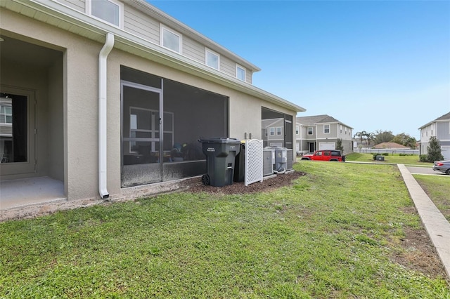255 Blueberry Ln, Davenport, FL 33837 - view of yard featuring a sunroom, a residential view, and central AC unit