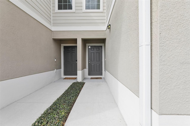 255 Blueberry Ln, Davenport, FL 33837 - doorway to property featuring stucco siding