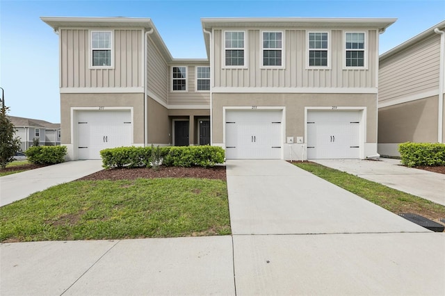 255 Blueberry Ln, Davenport, FL 33837 - townhome / multi-family property with board and batten siding, stucco siding, driveway, and a garage