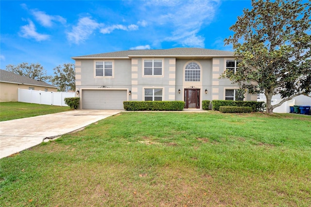 view of front of house with driveway, a garage, fence, a front lawn, and stucco siding