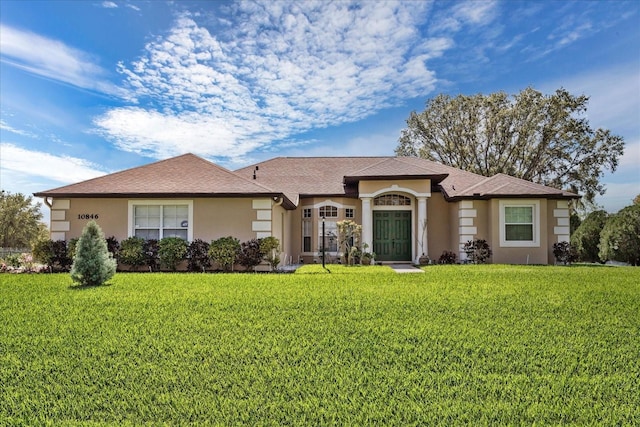 single story home with a front lawn and stucco siding