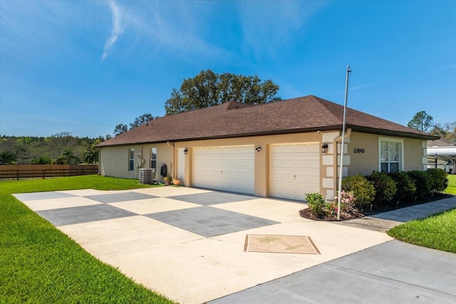 ranch-style house featuring central AC, fence, concrete driveway, stucco siding, and a front yard