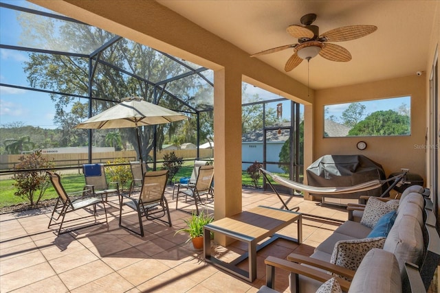 view of patio / terrace with glass enclosure, an outdoor hangout area, area for grilling, fence, and a ceiling fan