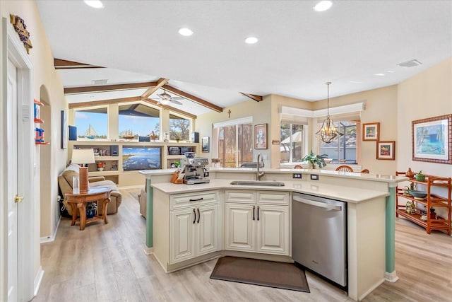 kitchen with light countertops, stainless steel dishwasher, a sink, and light wood-style flooring