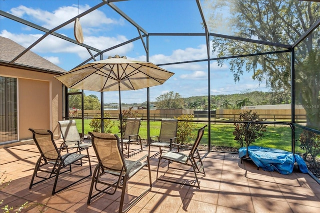 view of patio featuring a lanai and fence