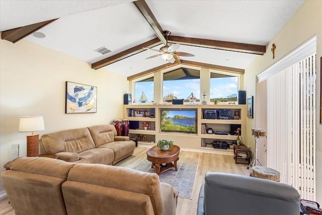 living room featuring visible vents, ceiling fan, lofted ceiling with beams, and wood finished floors