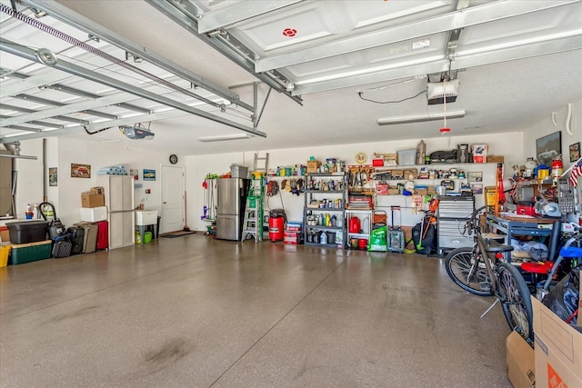 garage with water heater, freestanding refrigerator, and a garage door opener