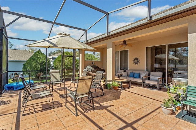 view of patio / terrace featuring a lanai, outdoor lounge area, and a ceiling fan