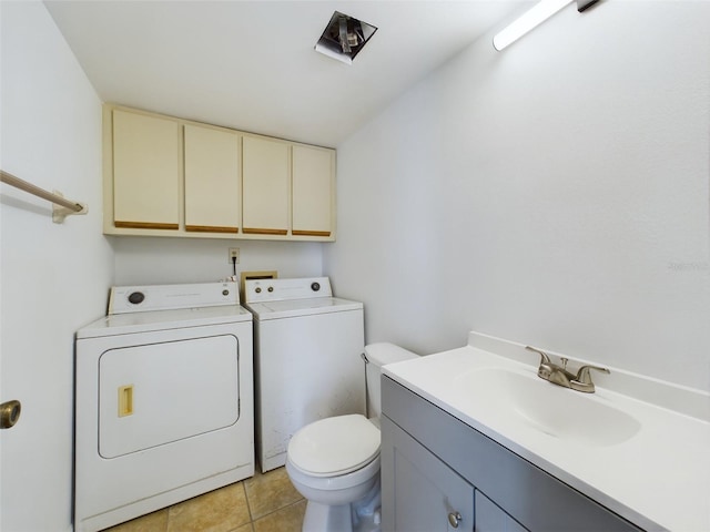 clothes washing area featuring a sink, laundry area, light tile patterned floors, and washer and dryer