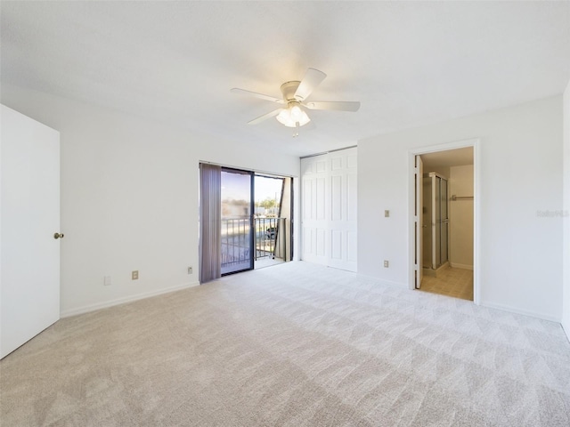 spare room with light colored carpet, ceiling fan, and baseboards