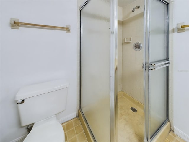 full bathroom with a shower stall, toilet, and tile patterned floors