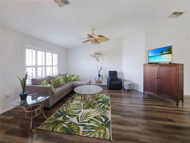 living room featuring lofted ceiling, ceiling fan, dark wood-style floors, and visible vents