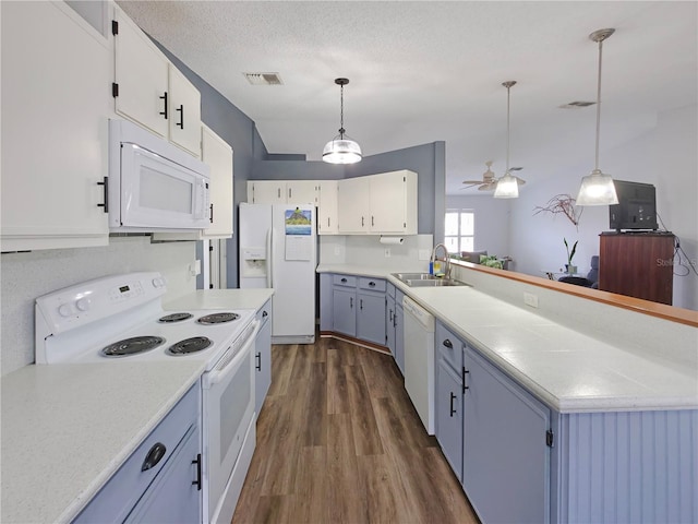 kitchen featuring light countertops, white appliances, a sink, and visible vents